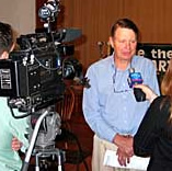 Rudy talking to the press at a SPARC  meeting